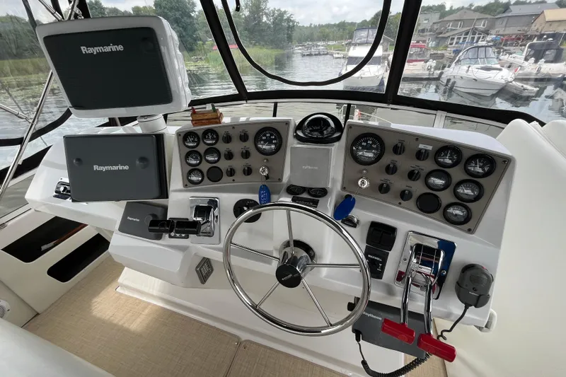  Yacht Photos Pics Helm of 2000 Carver 404 Cockpit Motor Yacht with Raymarine navigation equipment.