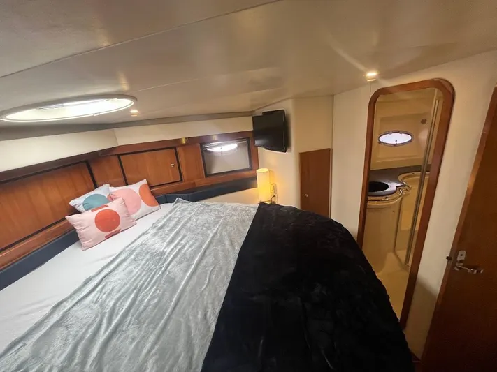 Permanent Waves Yacht Photos Pics Cozy bedroom inside 2000 Carver 440 Hardtop Express yacht with modern decor and soft lighting.