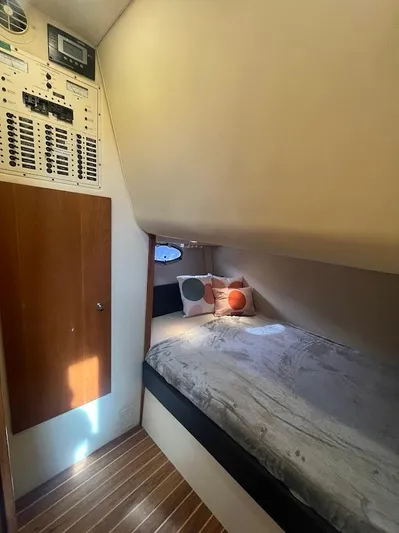 Permanent Waves Yacht Photos Pics Cozy cabin interior of 2000 Carver 440 Hardtop Express with bed and control panel.