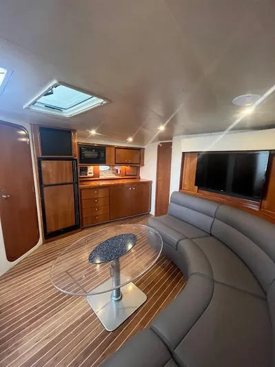 Permanent Waves Yacht Photos Pics Interior of 2000 Carver 440 Hardtop Express yacht with modern furnishings and wood accents.