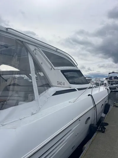 Permanent Waves Yacht Photos Pics 2000 Carver 440 Hardtop Express yacht docked under cloudy skies.