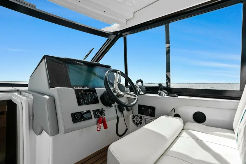 Over The Top Yacht Photos Pics 2021 Regal 36 boat interior with modern helm and steering wheel.