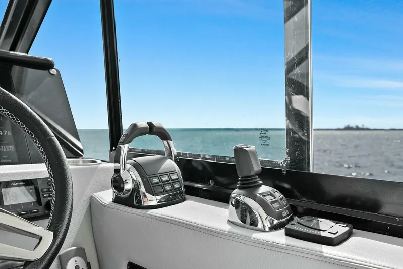 Over The Top Yacht Photos Pics Cockpit controls of a 2021 Regal 36 boat with ocean view.