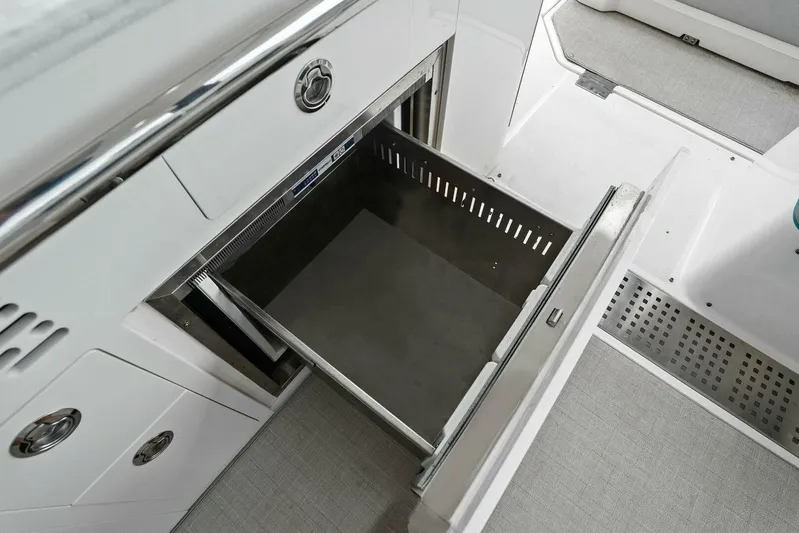 Over The Top Yacht Photos Pics Open storage compartment on a 2021 Regal 36 boat, featuring sleek design and modern amenities.