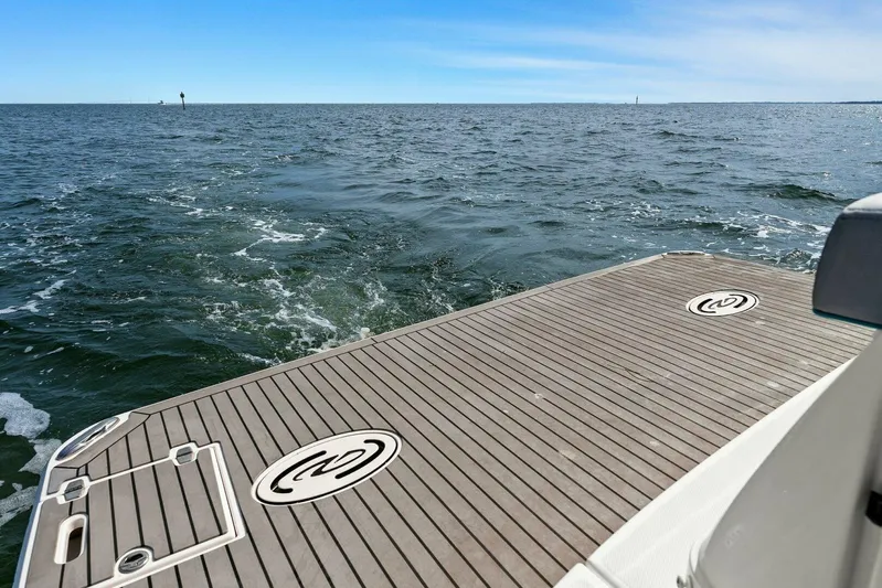 Over The Top Yacht Photos Pics 2021 Regal 36 boat deck overlooking the ocean under a clear blue sky.