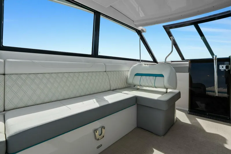 Over The Top Yacht Photos Pics Luxurious interior of 2021 Regal 36 boat with elegant seating and large windows.