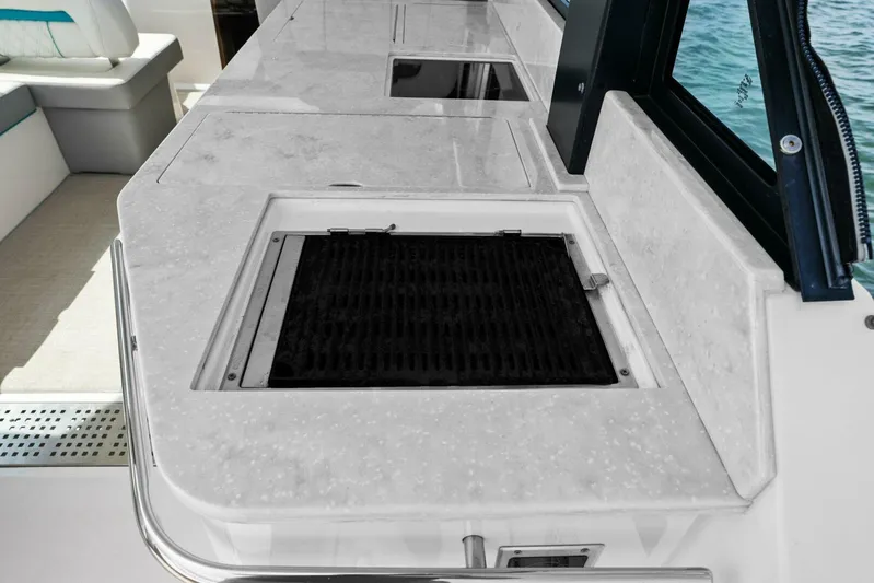 Over The Top Yacht Photos Pics Outdoor kitchen area on a 2021 Regal 36 boat with built-in grill.