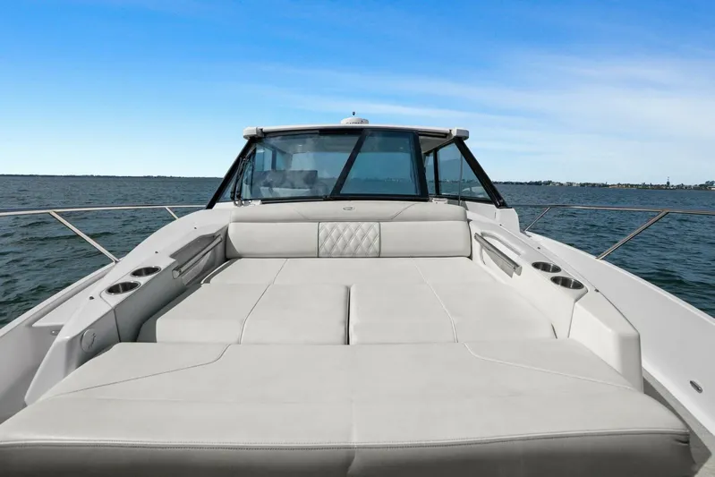 Over The Top Yacht Photos Pics 2021 Regal 36 boat with spacious deck seating on open water.