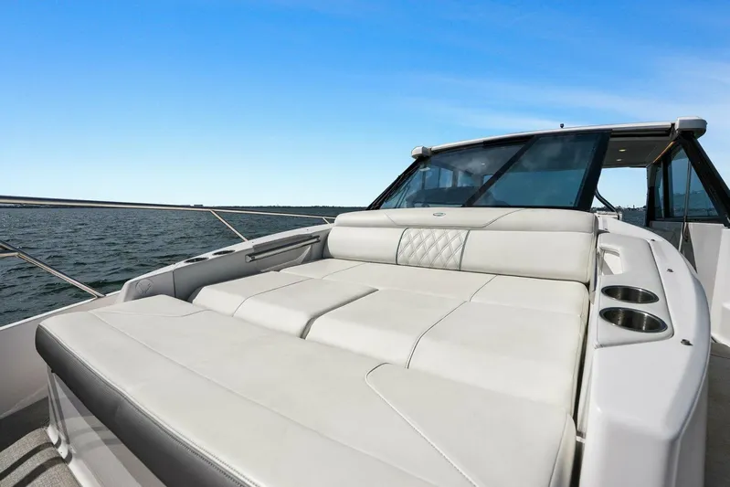 Over The Top Yacht Photos Pics 2021 Regal 36 boat with spacious sunbed on open water.