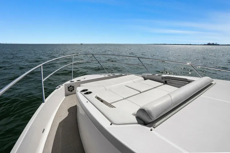 Over The Top Yacht Photos Pics 2021 Regal 36 boat with sun deck on open water under clear blue sky.