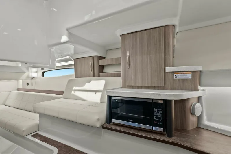 Over The Top Yacht Photos Pics 2021 Regal 36 interior with modern kitchen and seating area.