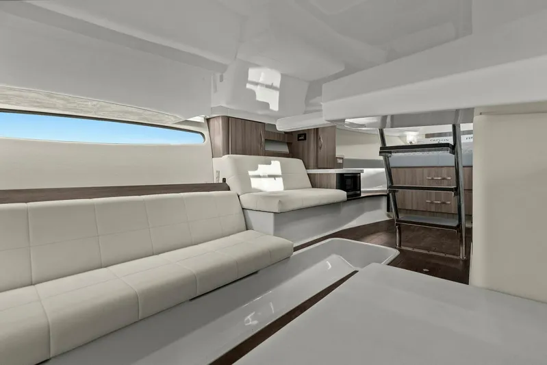Over The Top Yacht Photos Pics Luxurious interior of a 2021 Regal 36 yacht with modern seating and sleek design.