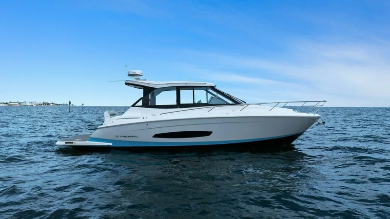 Over The Top Yacht Photos Pics 2021 Regal 36 boat cruising on open water under clear blue sky.