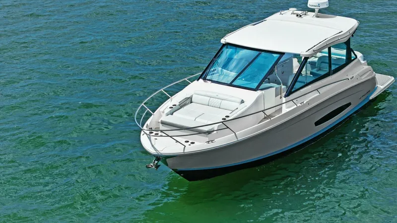 Over The Top Yacht Photos Pics 2021 Regal 36 boat on clear water, showcasing sleek design and modern features.