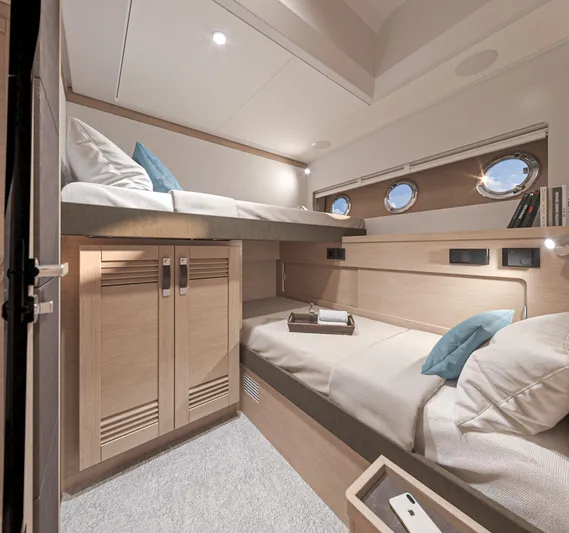  Yacht Photos Pics Interior cabin of 2025 Beneteau Swift Trawler 54 with bunk beds and portholes.