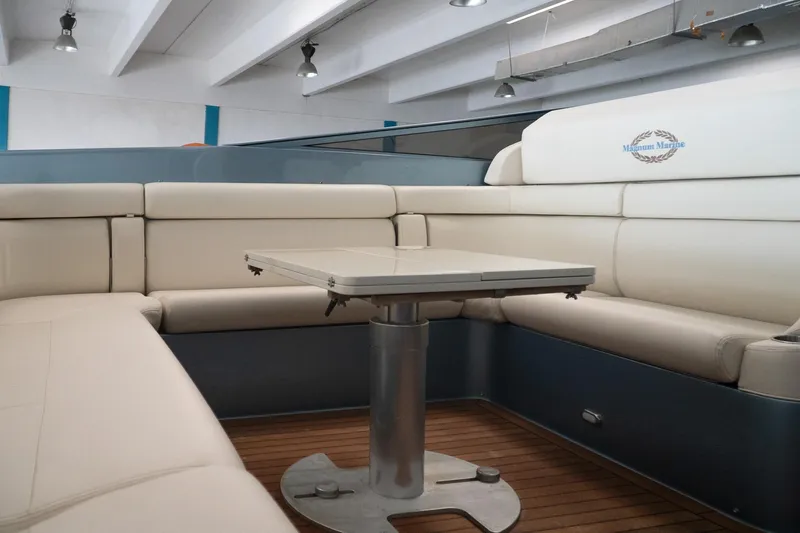  Yacht Photos Pics Luxurious interior of a 1997 Magnum 56 yacht with elegant seating and table.