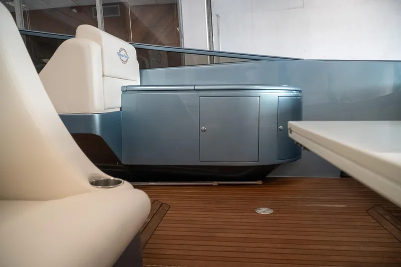  Yacht Photos Pics Interior of a 1997 Magnum 56 yacht with sleek seating and wooden flooring.