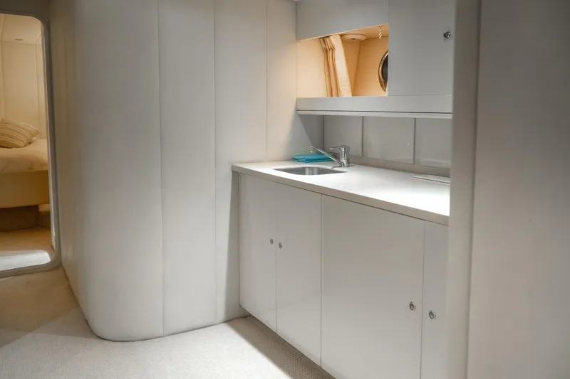  Yacht Photos Pics Interior of 1997 Magnum 56 yacht with sleek white cabinetry and modern sink.