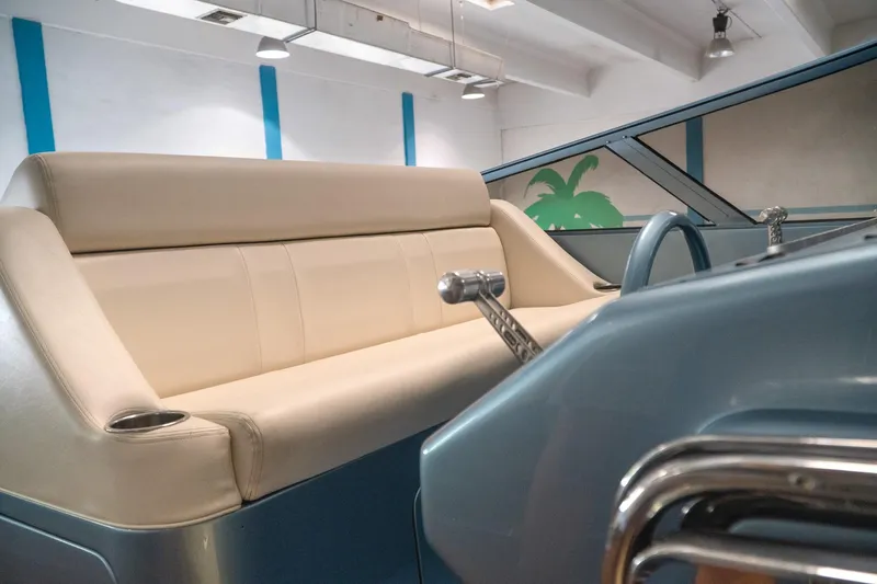  Yacht Photos Pics Interior of a 1997 Magnum 56 boat with beige seating and blue accents.