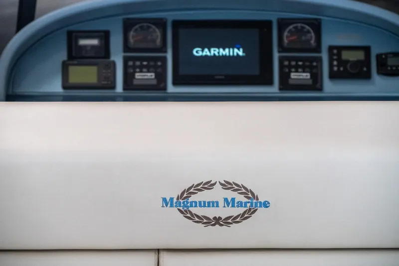  Yacht Photos Pics 1997 Magnum 56 boat dashboard with Garmin navigation system and Magnum Marine logo.
