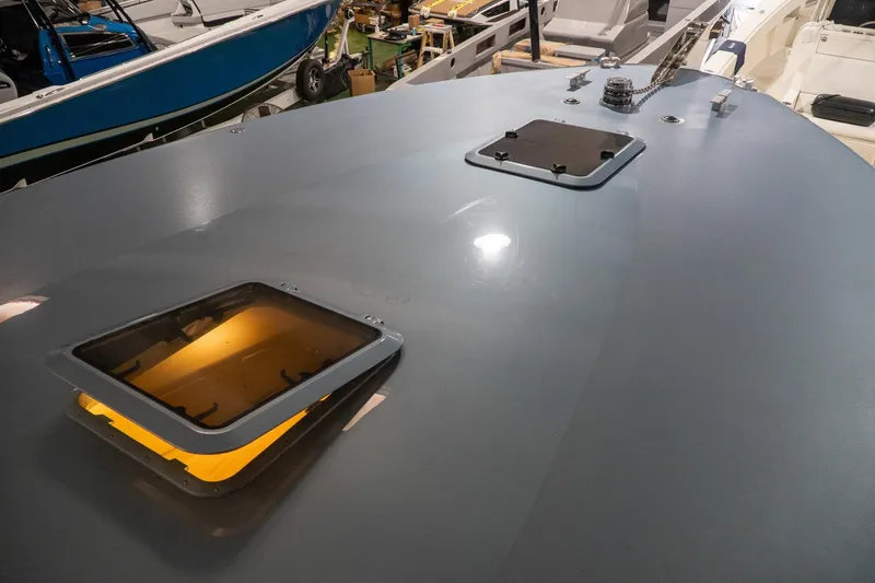  Yacht Photos Pics 1997 Magnum 56 yacht deck with open hatches in a boatyard setting.