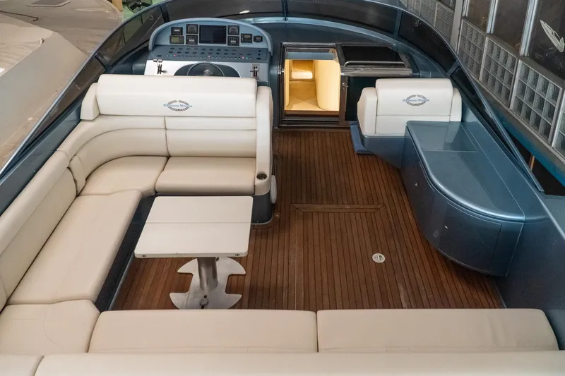  Yacht Photos Pics Luxurious 1997 Magnum 56 yacht interior with elegant seating and wooden flooring.