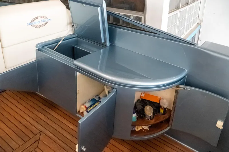  Yacht Photos Pics Luxury yacht interior with storage cabinets, Magnum 56, 1997 model, featuring wooden flooring.