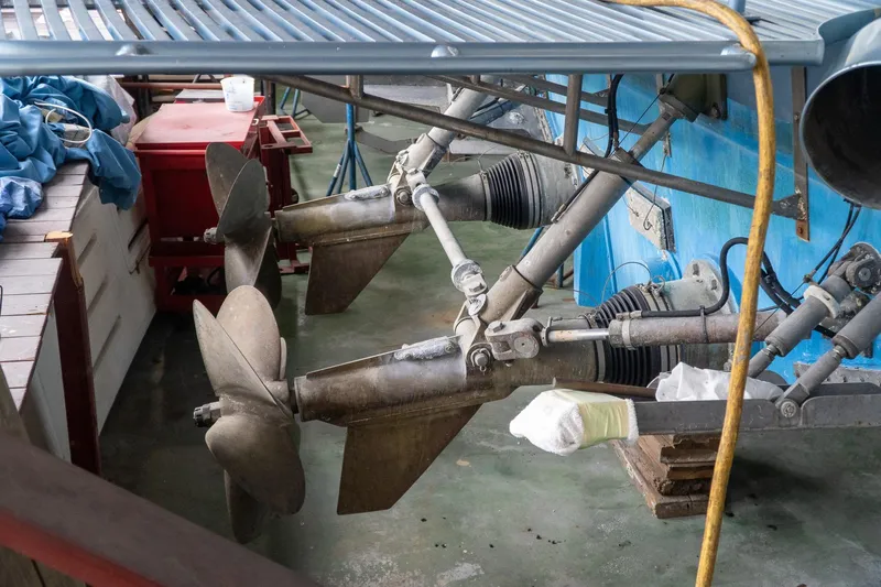  Yacht Photos Pics Dual propellers of a 1997 Magnum 56 boat in a maintenance area.