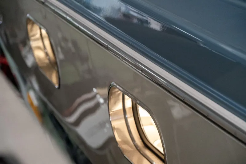  Yacht Photos Pics Close-up of 1997 Magnum 56 vehicle windows with reflective surface.