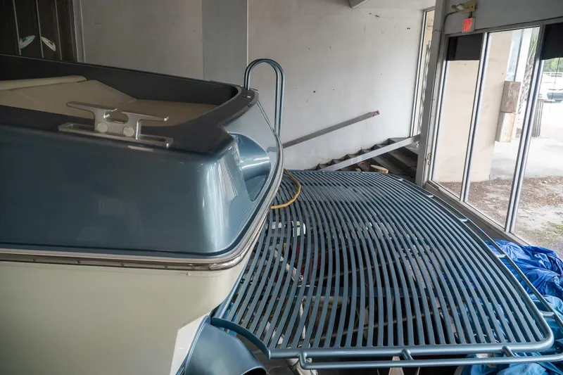  Yacht Photos Pics 1997 Magnum 56 boat in storage, featuring a sleek blue and white design.