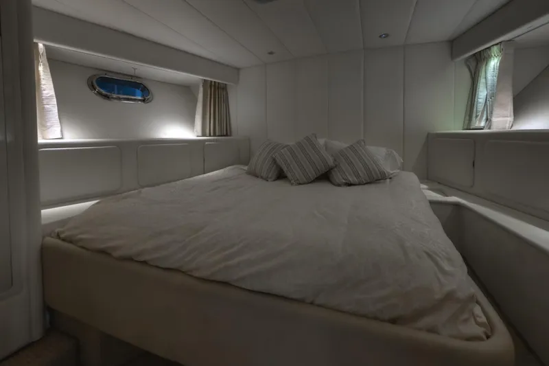  Yacht Photos Pics Luxurious cabin interior of 1997 Magnum 56 yacht with cozy bed and pillows.