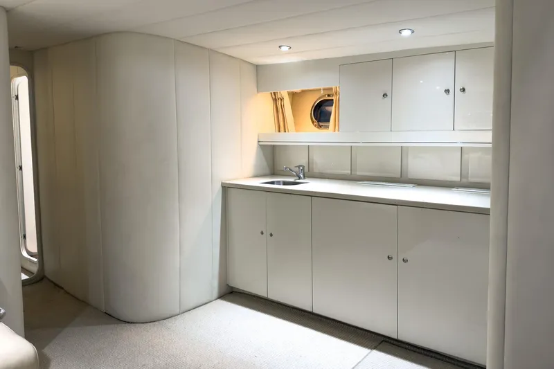  Yacht Photos Pics Luxurious interior of 1997 Magnum 56 yacht with sleek white cabinetry and modern lighting.