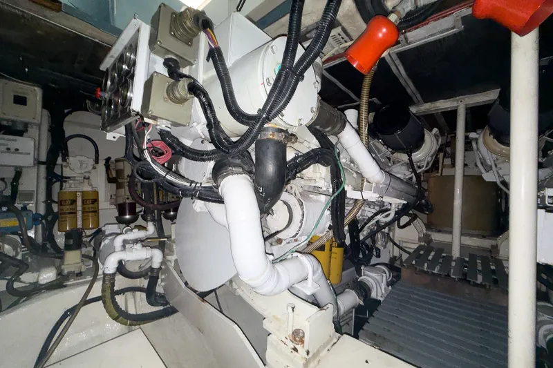  Yacht Photos Pics Engine room of a 1997 Magnum 56 yacht, showcasing complex machinery and wiring.