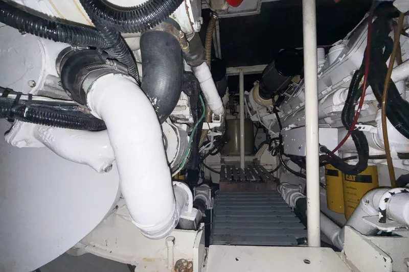  Yacht Photos Pics Engine room of a 1997 Magnum 56 yacht, featuring pipes and mechanical components.