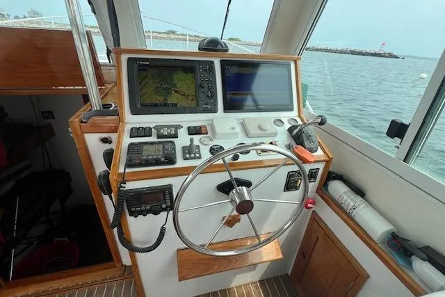 Tere Sue Yacht Photos Pics 2007 Northern Bay Hardtop Cruiser helm with navigation equipment and steering wheel.