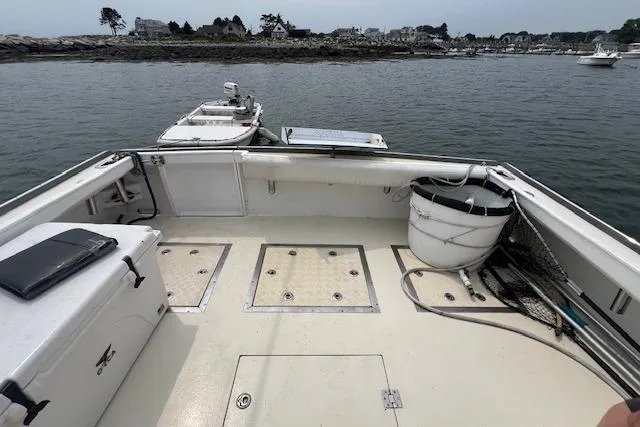 Tere Sue Yacht Photos Pics 2007 Northern Bay Hardtop Cruiser/Fishing Vessel with spacious deck, docked near rocky shoreline.