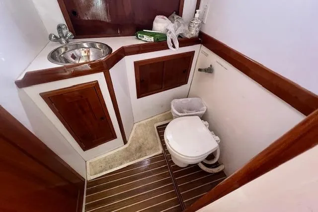 Tere Sue Yacht Photos Pics 2007 Northern Bay Hardtop Cruiser bathroom with wooden cabinetry and compact toilet.