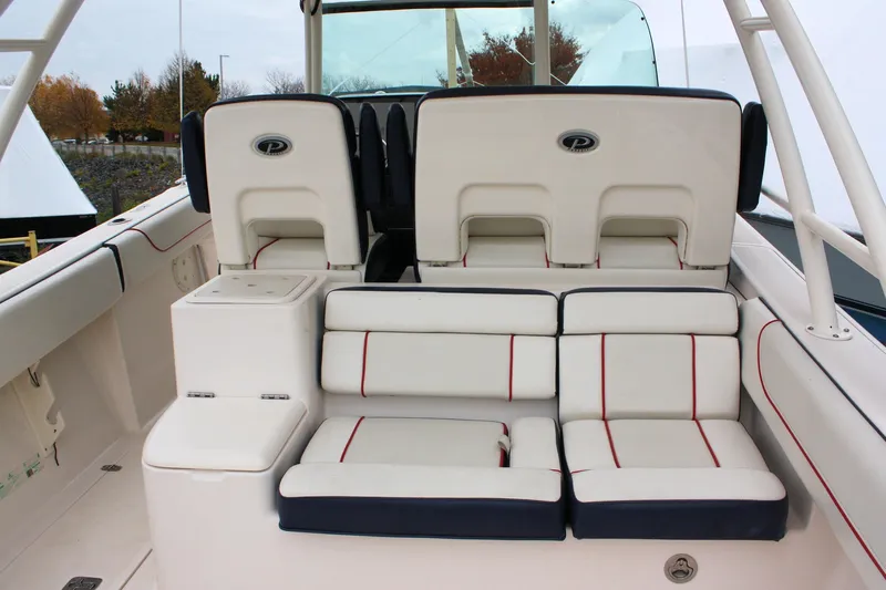  Yacht Photos Pics 2013 Pursuit ST 310 Sport boat interior with cushioned seating and storage compartments.