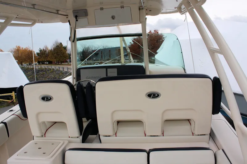  Yacht Photos Pics 2013 Pursuit ST 310 Sport boat interior with dual seats and Garmin navigation system.