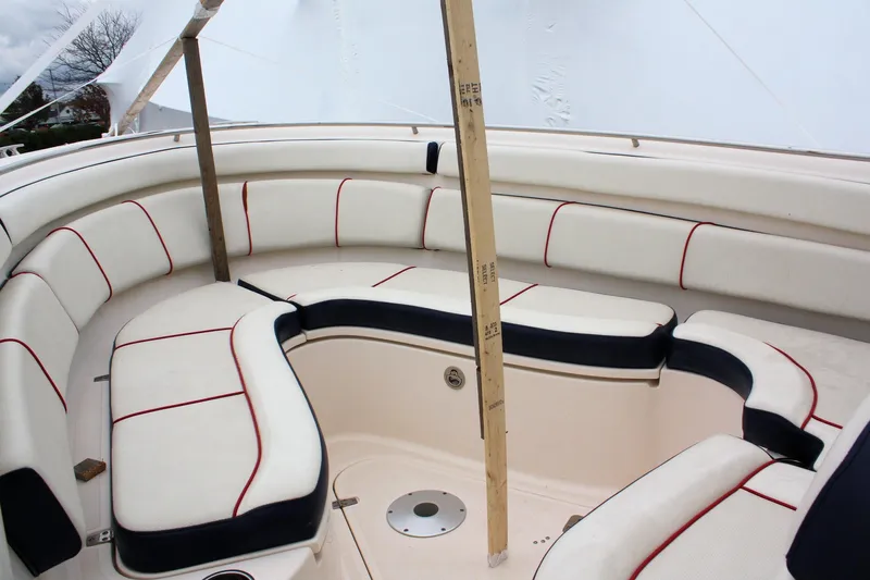  Yacht Photos Pics 2013 Pursuit ST 310 Sport boat interior with white and red cushioned seating.