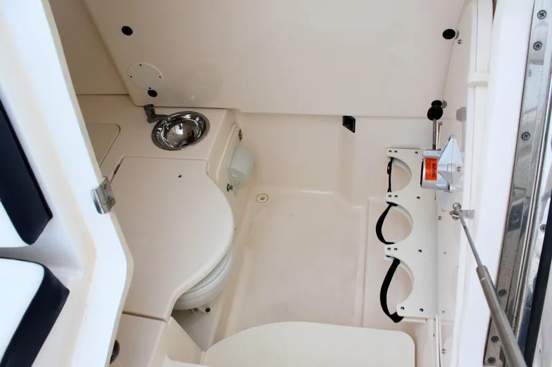  Yacht Photos Pics 2013 Pursuit ST 310 Sport boat interior with sink and storage compartments.