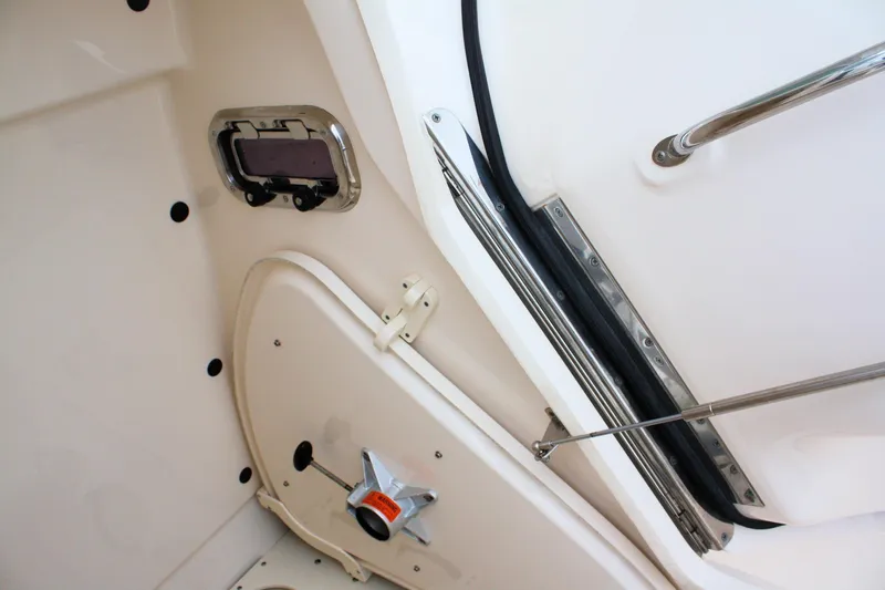  Yacht Photos Pics Interior view of a 2013 Pursuit ST 310 Sport boat, featuring a hatch and handle.