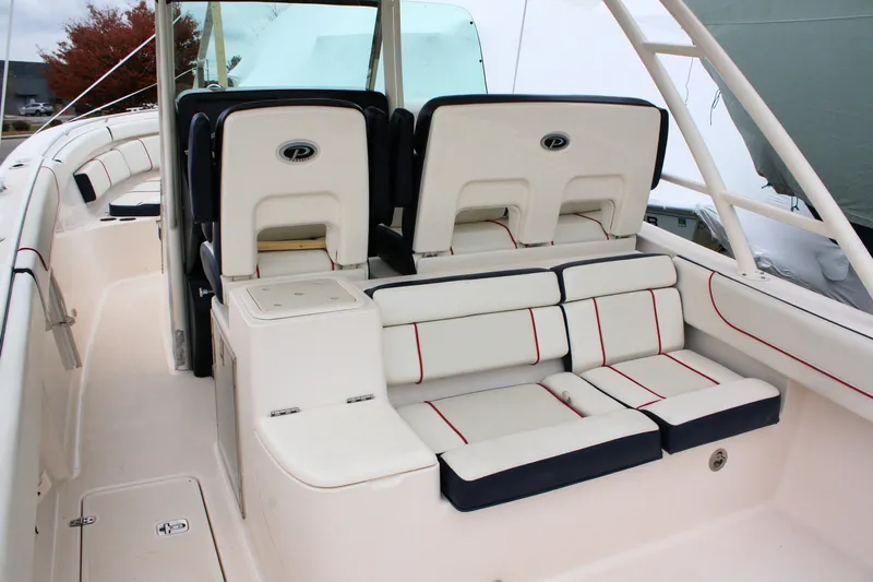  Yacht Photos Pics 2013 Pursuit ST 310 Sport boat interior with cushioned seating and helm chairs.