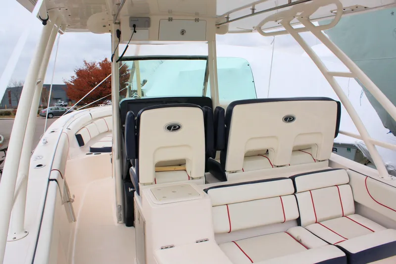  Yacht Photos Pics 2013 Pursuit ST 310 Sport boat interior with cushioned seating and helm station.