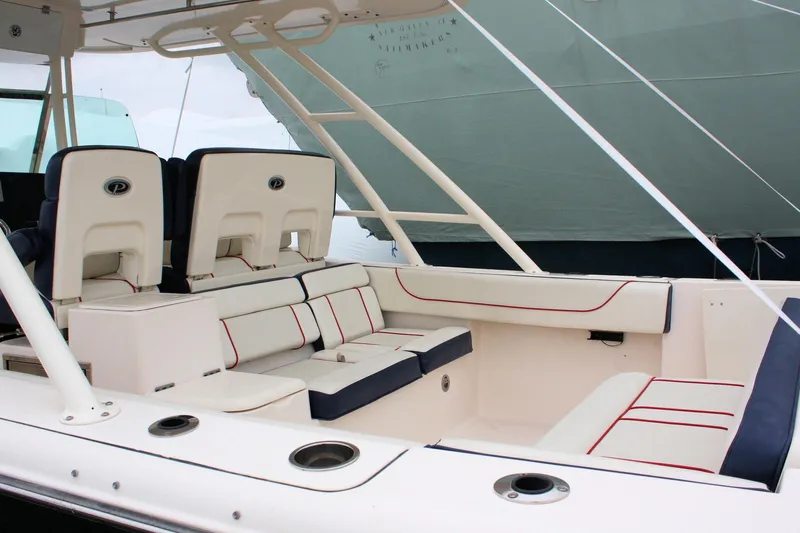  Yacht Photos Pics 2013 Pursuit ST 310 Sport boat interior with white and navy seating.