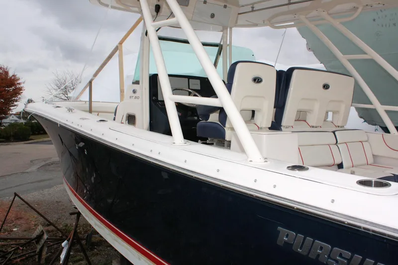  Yacht Photos Pics 2013 Pursuit ST 310 Sport boat with white seating and sleek design.