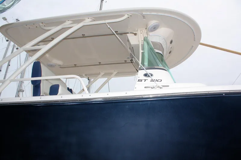  Yacht Photos Pics 2013 Pursuit ST 310 Sport boat, side view with canopy and seating.