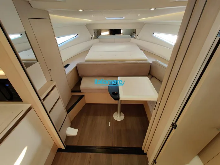  Yacht Photos Pics Interior of 2020 Jeanneau Leader 36 yacht, featuring a cozy cabin with bed and seating area.