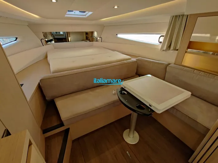  Yacht Photos Pics Luxurious interior of 2020 Jeanneau Leader 36 yacht with cozy seating and table.