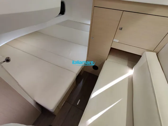  Yacht Photos Pics Interior cabin of 2020 Jeanneau Leader 36 yacht with beige seating and wooden cabinetry.